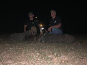 Bailey and Phillip celebrating a successful pig hunt.