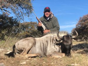 Louis S. With his Blue Wildebeest taken on a spot and stalk hunt!